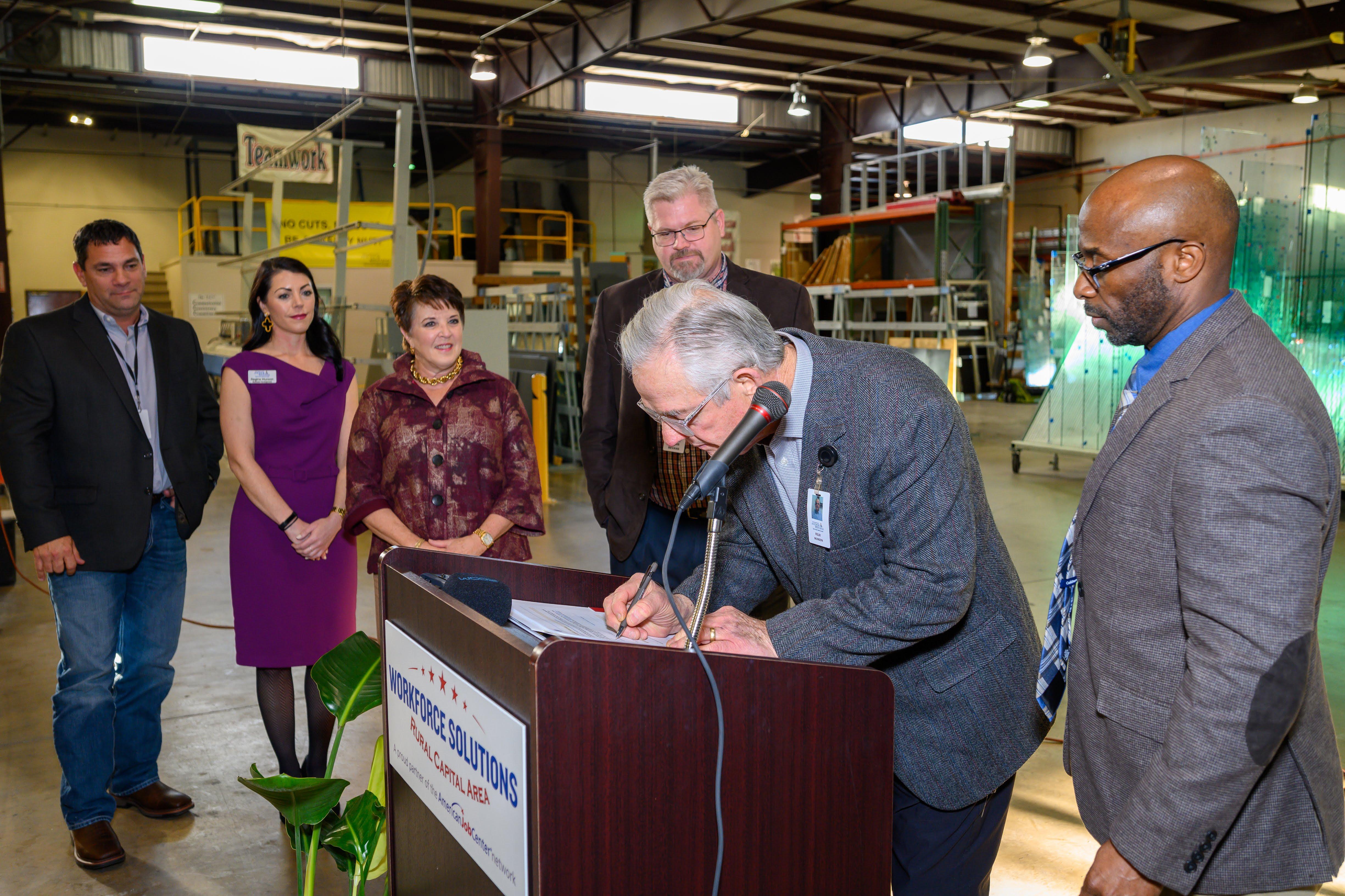 Anchor-Ventana Owner & President Felix Munson and his family, sign the U.S. Department of Labor Registered Apprenticeship Program Standards